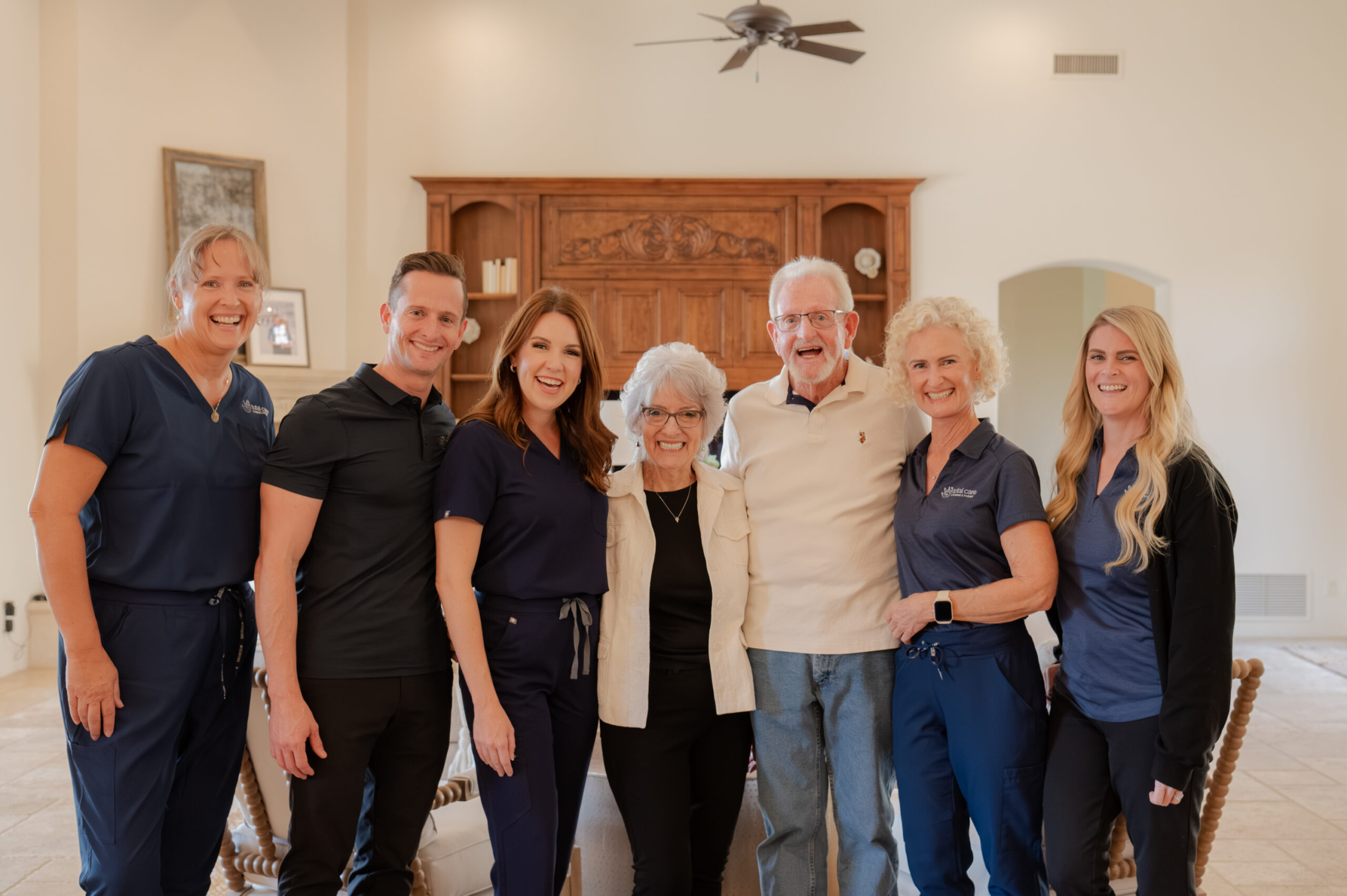 The Total Care Connections team smiling at the camera with a senior client.